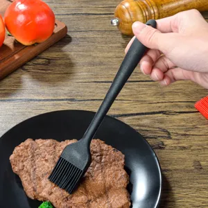 Black silicone basting brush for barbecue, baking, and kitchen cooking tasks.