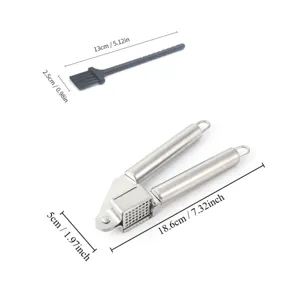 Stainless steel garlic press detail showing precise dimensions, essential kitchen tool view.