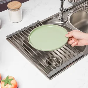 Stainless steel roll-up dish drying rack detail, showing kitchen sink placement and practical use.