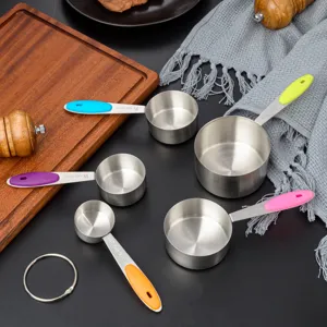 Stainless steel measuring cups and spoons set with colorful silicone handles for baking.