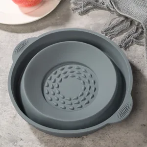 Gray collapsible silicone bowl for kitchen, folding salad bowl with textured bottom, detail view