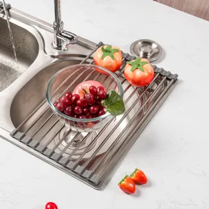 Stainless steel roll up dish drying rack over kitchen sink in modern home setting