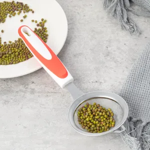 Stainless steel mesh kitchen strainer detail view featuring red and white handle for baking.