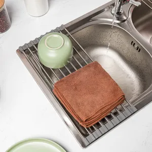 Stainless steel roll-up dish drying rack kitchen sink drainer organizer for bowls and plates.