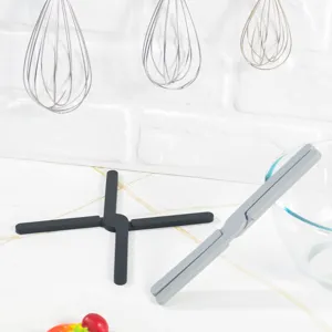 Detailed view of foldable silicone hot pad, flexible cross design kitchen trivet for safe anti scald.