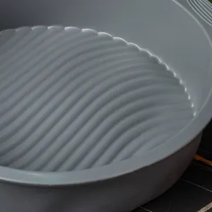 Round silicone cake mold detail, non-stick baking pan with wavy bottom design for DIY baking.