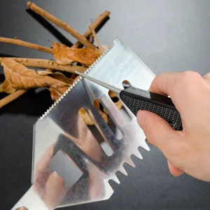 Detailed view of a compact outdoor sharpening tool in action, sharpening a jagged blade.