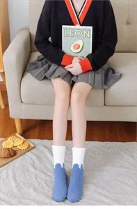 Thickened winter coral fleece socks for women, cozy color-block sleep socks for indoor home wear.