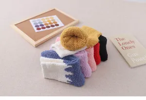 Thick coral fleece fuzzy socks for women, warm winter sleep socks with color block design.