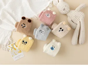 Detailed shot of cute embroidered coral fleece socks with animal faces, cozy sleep home socks.