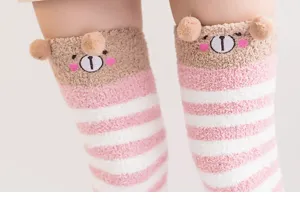 Cozy coral fleece striped knee-high socks with cute 3D bear ears for women home wear.