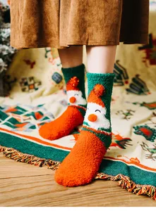 Cozy coral fleece Christmas Santa Claus design mid-tube socks detail shot with soft warm texture.