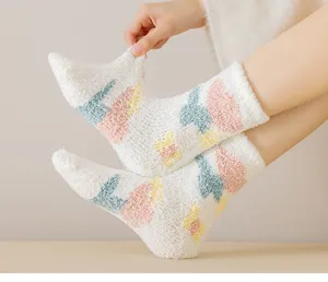 Fluffy winter coral fleece sleep socks featuring cute tulip patterns, cozy indoor footwear detail.