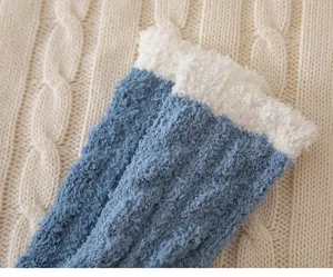 Detail view of winter thick cable knit coral fleece socks with cozy blue and white design.