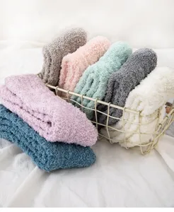 Fuzzy coral fleece home sleep socks detail shot, cozy thickened winter warm socks in basket.