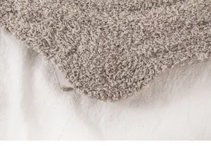 Cozy coral fleece winter sock fabric detail, soft thickened fuzzy texture for warm home sleep.