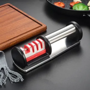 Close-up detail of the four-stage knife sharpener with ergonomic handle and stainless steel base.