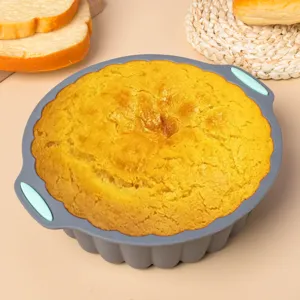Silicone cake mold with blue handles, non-stick baking pan for home kitchen pastries.