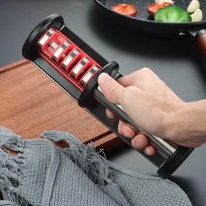Close up view of a multi stage kitchen knife sharpener with ergonomic handle and durable slots.