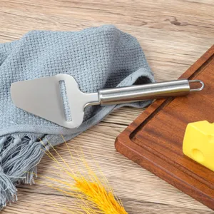 Detailed view of stainless steel cheese slicer on textured wooden tabletop and cutting board.