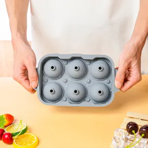 Detailed view of the 6-cavity grey silicone ice ball mold with handles for home kitchen use.
