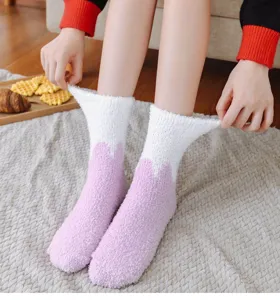 Close-up view of soft plush winter socks, cozy fluffy coral velvet material for indoor wear.
