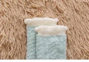 Soft coral fleece fuzzy socks cuff detail close-up view showing comfortable warm texture.