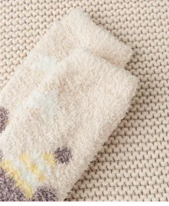 Close up view of thick fluffy coral fleece sleep socks, soft warm winter fuzzy home socks detail.