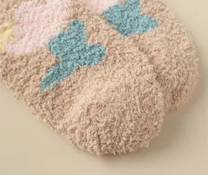 Soft cozy fuzzy coral fleece socks detail, thick warm winter sleep socks texture close-up