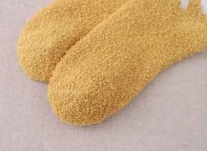 Soft coral fleece sock detail showing thick fluffy texture and cozy warm yellow fabric.