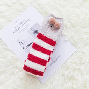 Winter cozy coral fleece striped over-the-calf socks with cute plush ball decor for women.