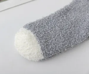 Close-up detail of cozy thick coral fleece fuzzy winter socks with soft contrast toe design.
