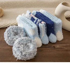 Close-up detail of cozy blue coral fleece fuzzy socks rolled and arranged neatly for winter.