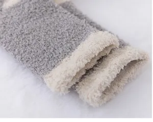 Cozy coral fleece winter sock detail, soft plush texture and warm grey white patchwork design.