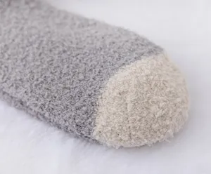 Close-up detail of winter thick coral fleece socks toe, soft cozy fabric, cozy sleep wear.