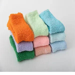 Detailed view showcasing the thick, soft coral fleece texture and vibrant sock colors.