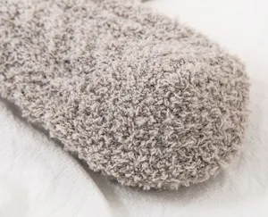 Close-up detail of ultra-soft thick coral fleece winter sleep socks showing plush texture.