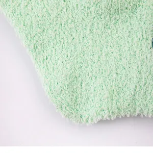 Close-up detail of soft green fleece material, showing fluffy and warm texture clearly.