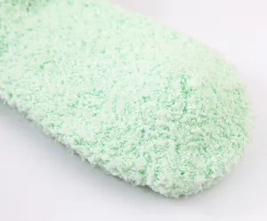 Soft coral fleece fuzzy sleeping socks close up, thick warm solid color winter thermal home socks.