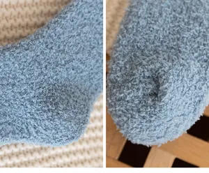 Detailed close-up showing soft fluffy coral fleece texture of blue winter thermal floor socks.