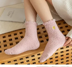 Pink fuzzy fleece mid-calf socks with cute heart embroidery for cozy winter home wear detail view