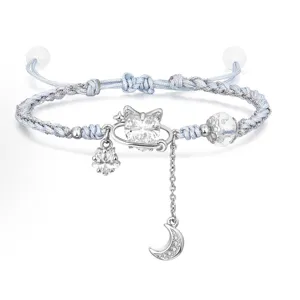 Handmade braided blue bracelet with rhinestone cat and moon charms, stylish adjustable jewelry.