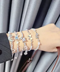 Handcrafted woven crystal zircon rhinestone stackable charm bracelets wrist detail view.