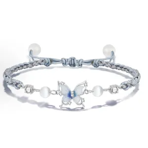 Blue woven butterfly bracelet with zirconia stones and cat's eye pearls, adjustable.