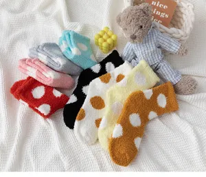 Cozy fuzzy coral fleece socks for women, thick winter warm sleep socks with cute polka dots.