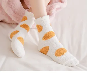 Cozy thick coral fleece fuzzy winter socks detail shot, soft plush warm sleep socks close-up view.