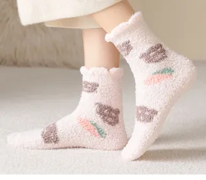 Soft coral fleece socks featuring cute bear and carrot patterns, shown in detail.
