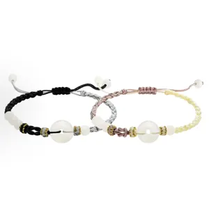 Close-up of handmade woven couple bracelets featuring imitation jade safety buckles and delicate beads.