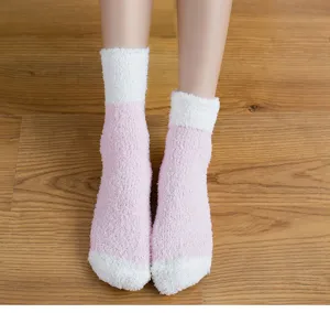 Soft coral fleece socks detail shot, pink and white color block design for cozy home wear.