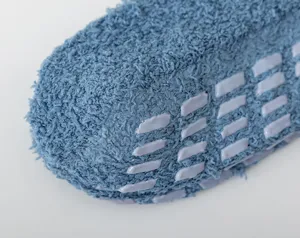 Detailed close-up of winter thick coral fleece warm socks with anti-slip silicone grip sole.